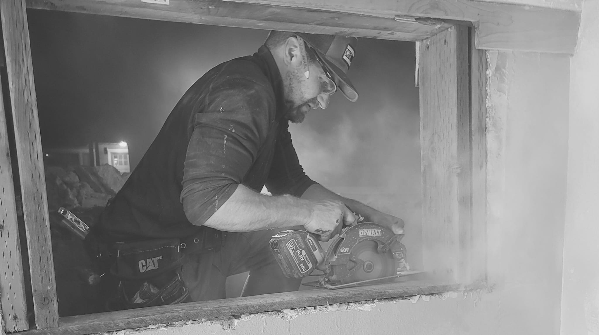 JD Carpentry Services carpenter cutting wood with a circular saw on a job site